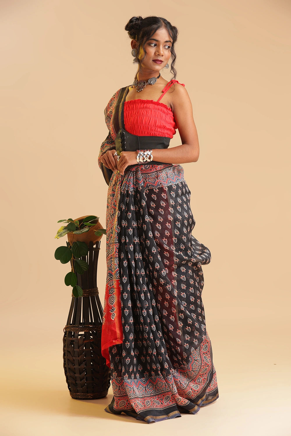Studio standing view showcasing the graceful drape and rich black and red color palette of the handblock printed Chanderi cotton-silk saree
