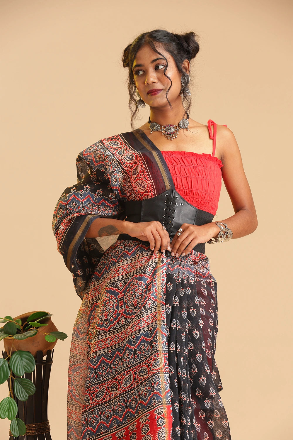 Studio mid-shot highlighting the upper body drape, handblock printed pattern details, and lightweight luster of the black Chanderi cotton-silk saree