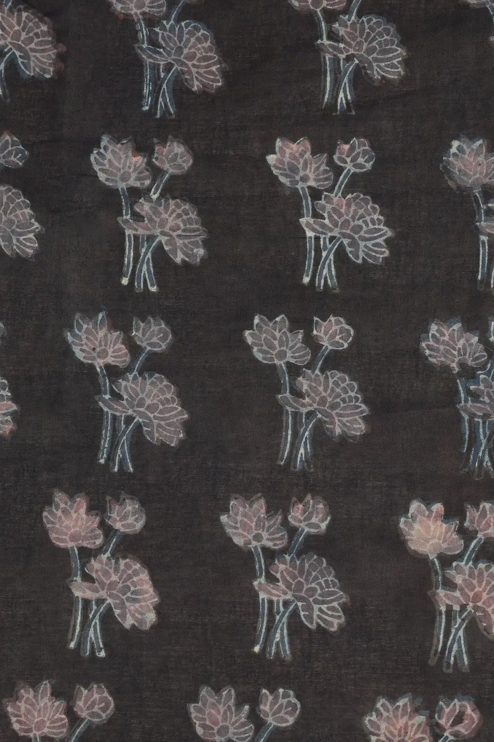 Close-up view of the rich black cotton base highlighting the delicate pink lotus motifs created via Bagru printing