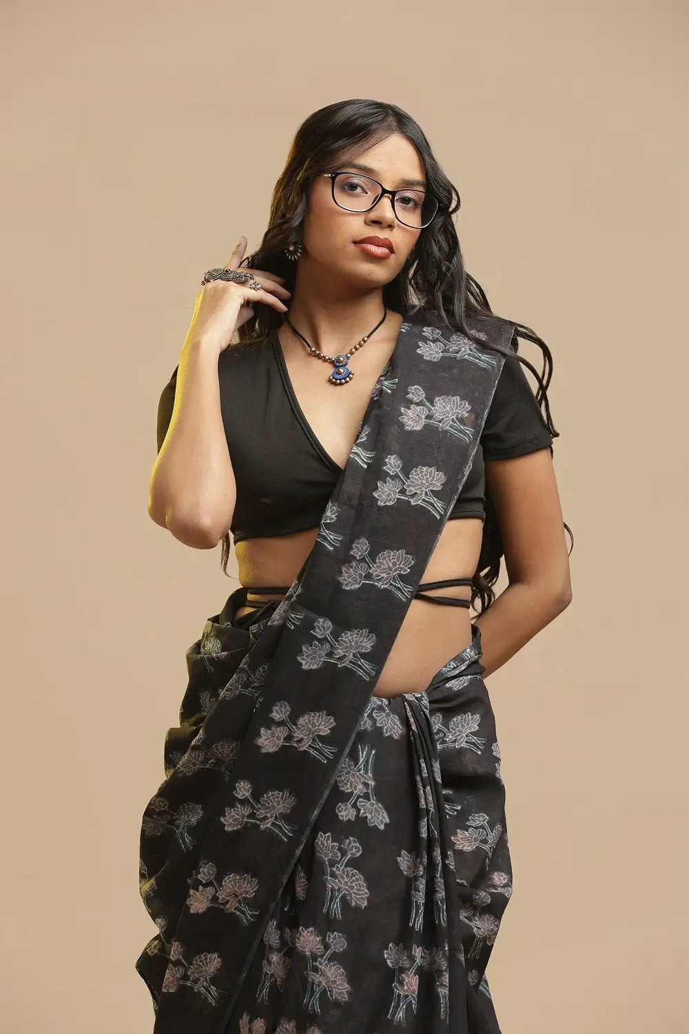 Model posing in the black and green Bagru hand-block printed cotton saree against a neutral studio background
