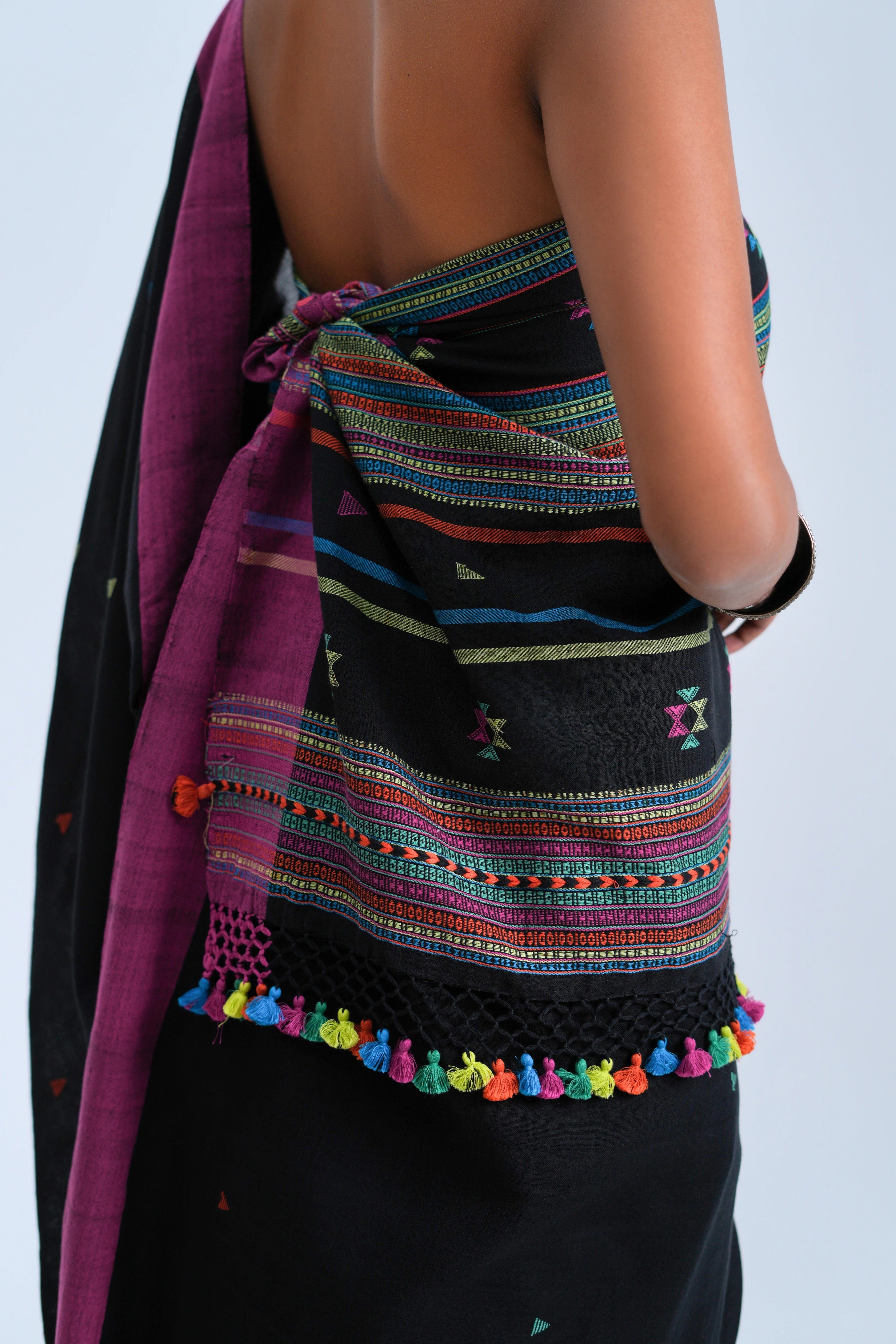 Close-up view of the detailed horizontal stripe pallu finished with a crochet-lace edge and vibrant multicolour tassel fringe