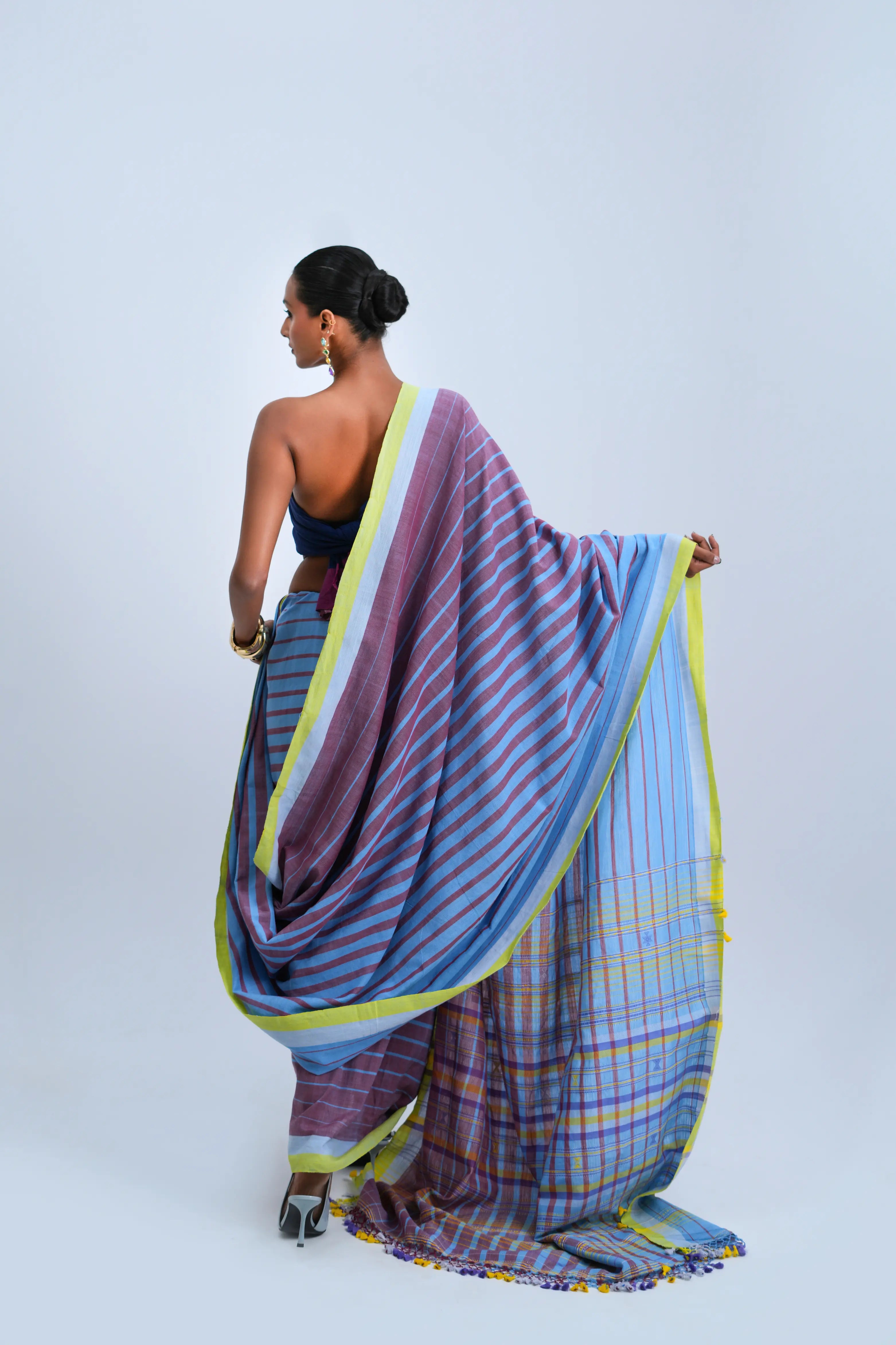 Rear full-length view of a model displaying the detailed multicolour check pallu and complete stripe alignment