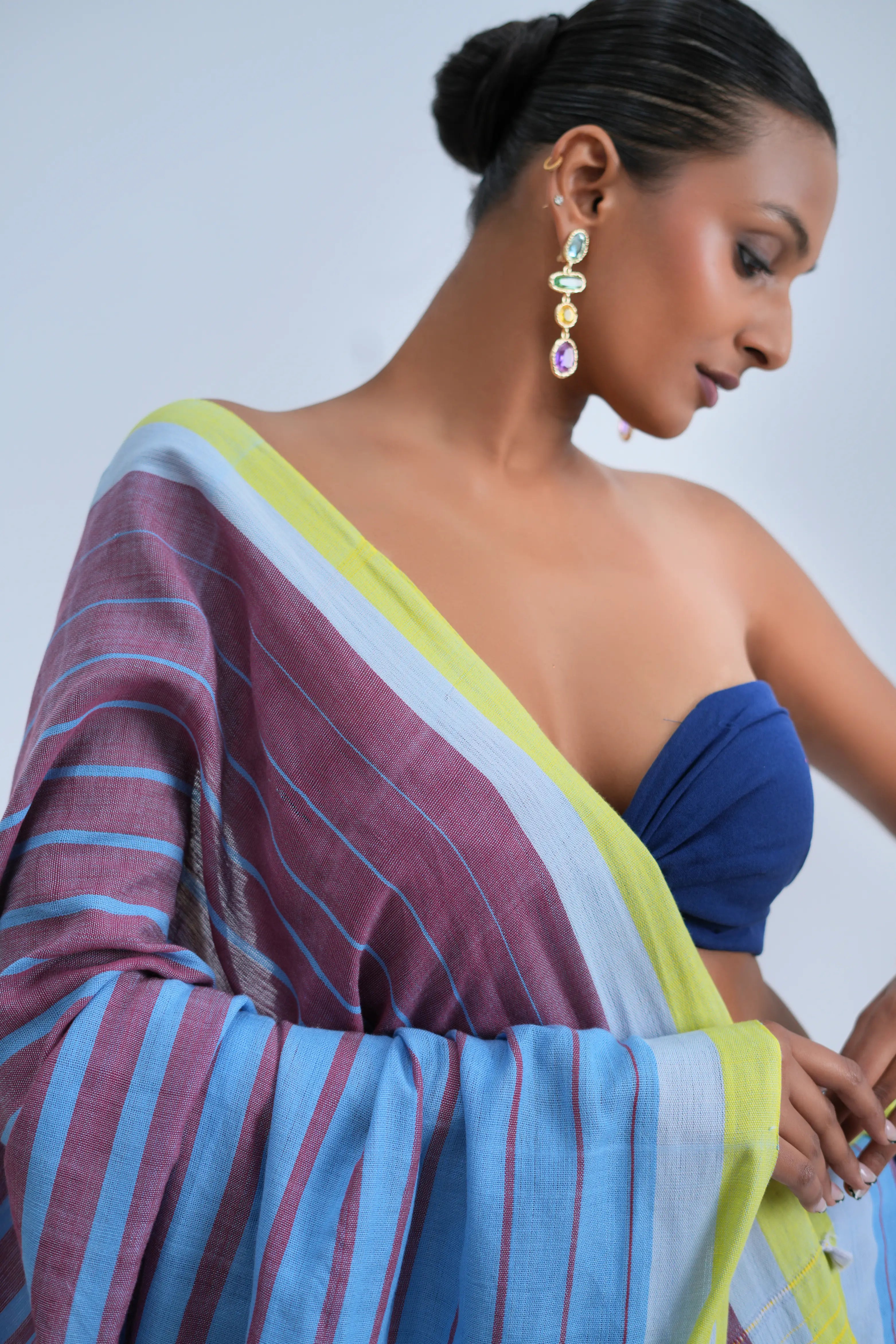 Close-up studio view of the shoulder drape showcasing the crisp lime-yellow border and alternating sky blue and mauve stripe weave