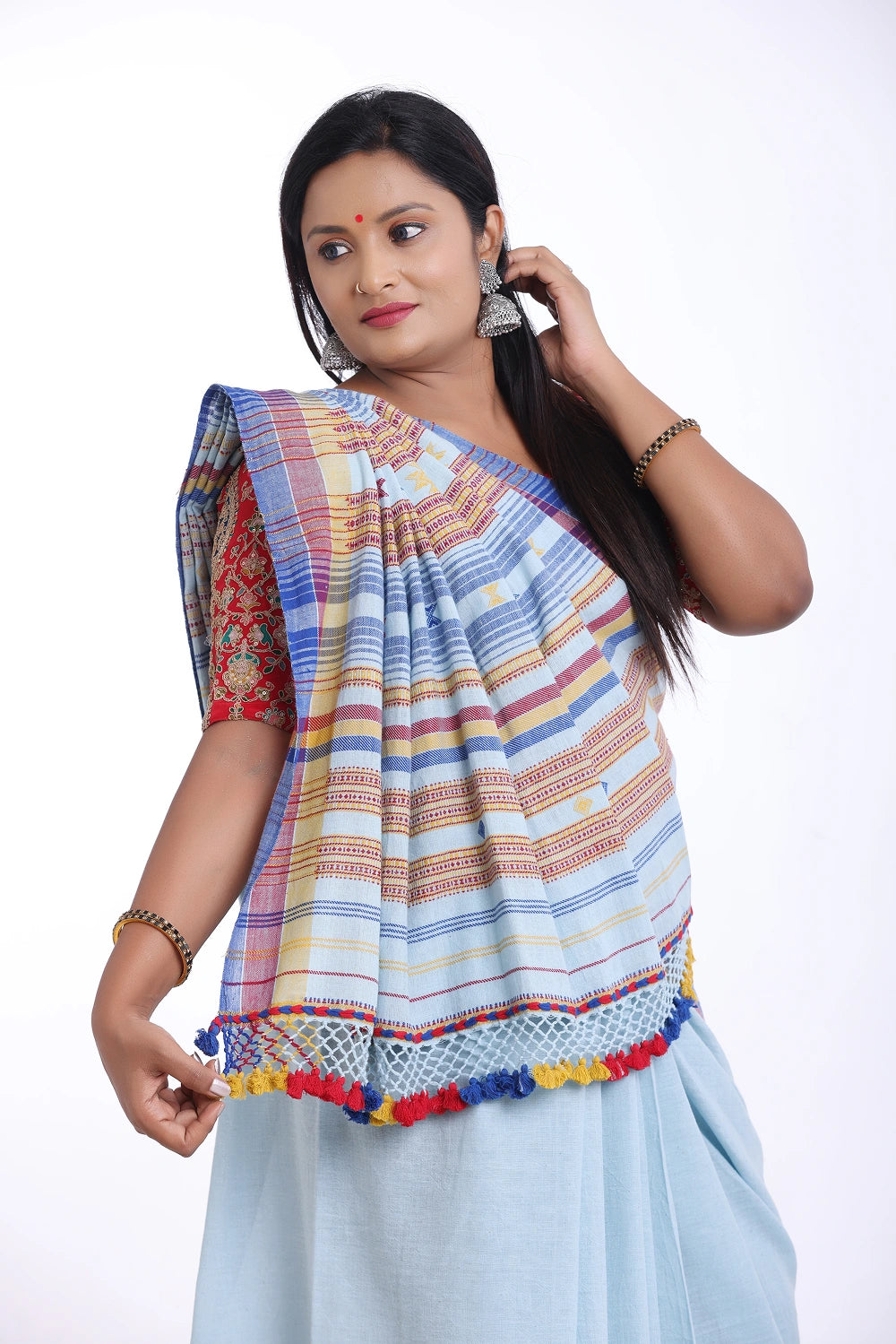 Close-up front view highlighting the shoulder drape, patterned blouse pairing, and vibrant border details