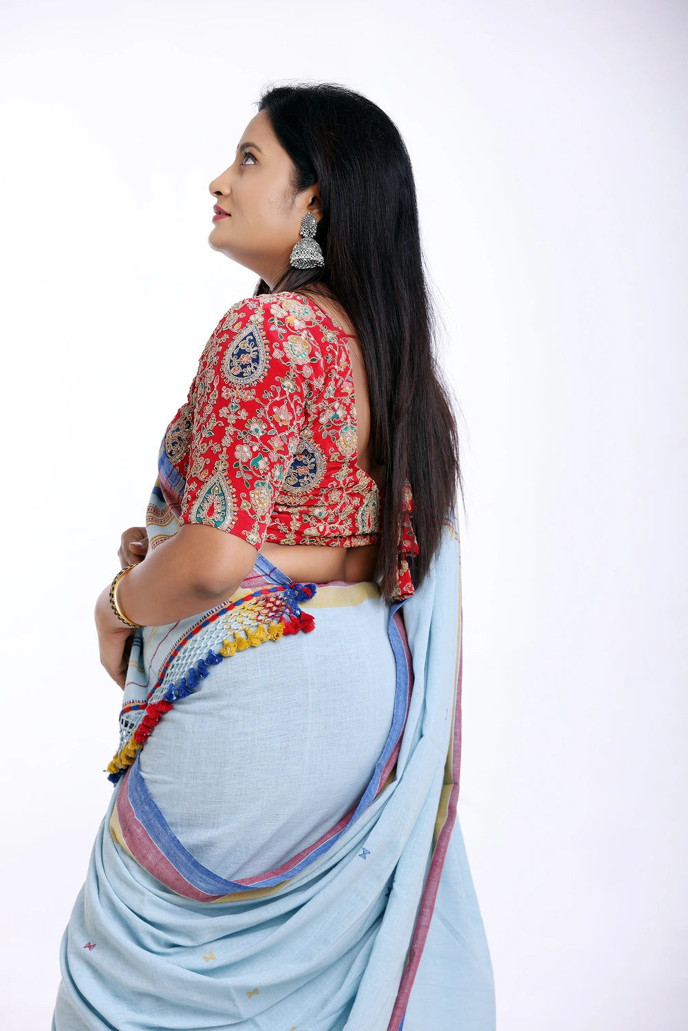 Side-profile studio view showcasing the graceful drape, pleat alignment, and detailed pallu structure of the Bhujodi saree
