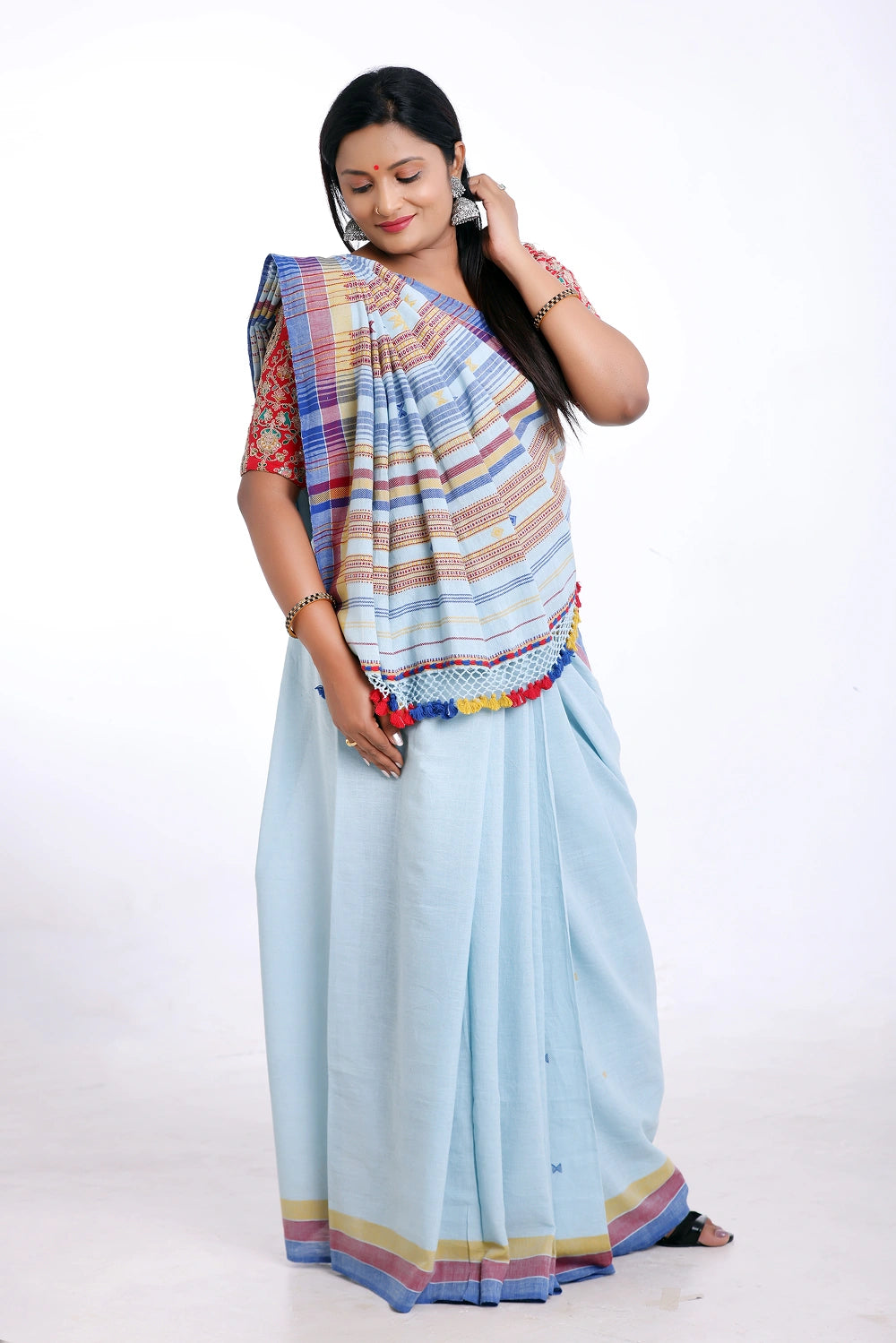 Standing front studio pose highlighting the complete length and color coordination of the Bhujodi saree