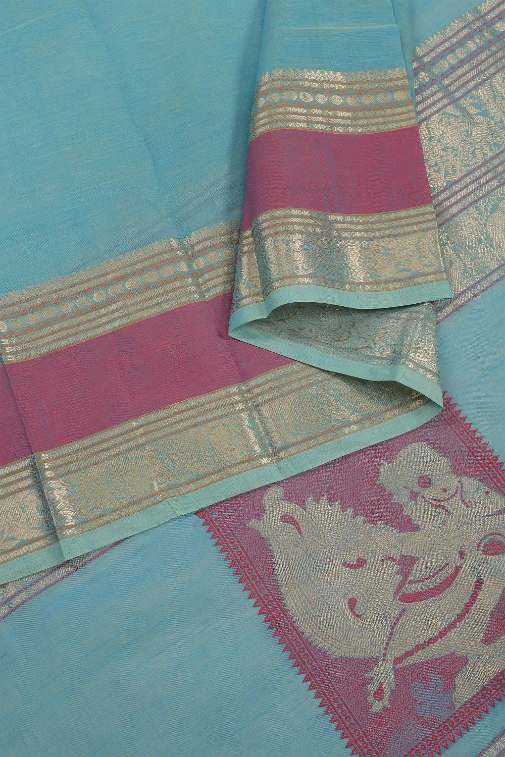 Close-up view of the gold zari border and pastel blue handloom cotton drape