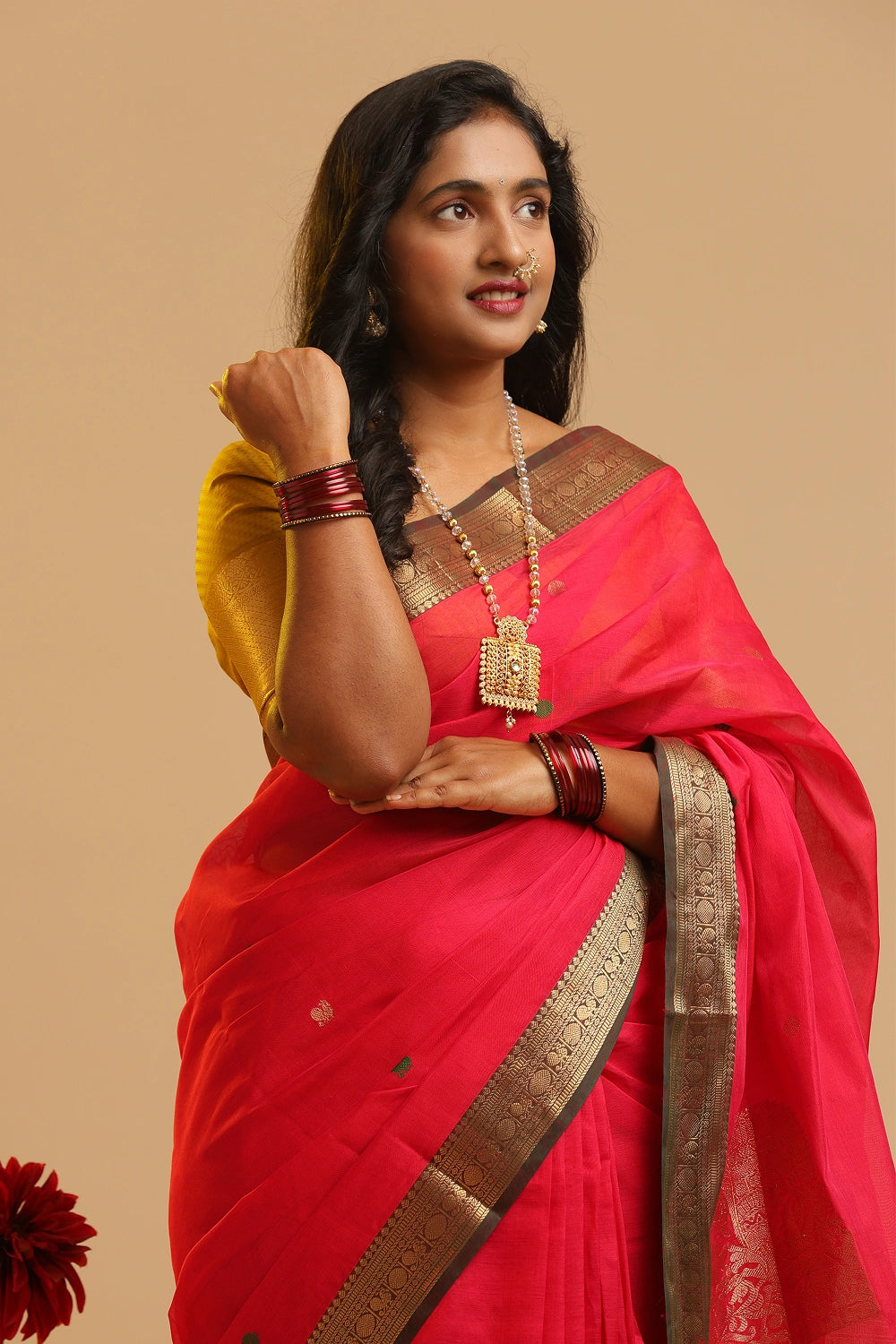 Corner Butta Kanchipuram handloom silk cotton saree in vibrant red with traditional dark border displayed by a model