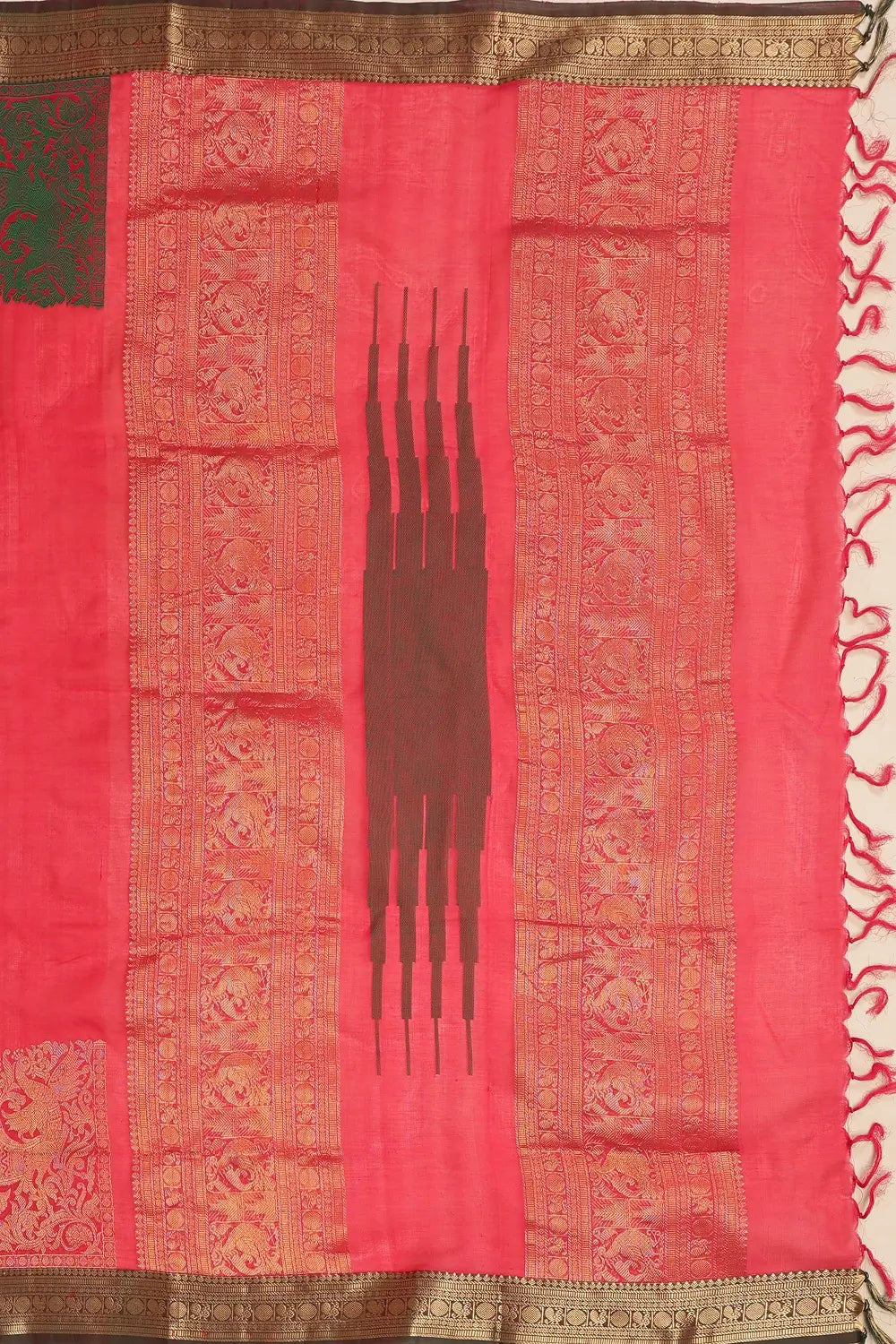 Detailed view of the pallu showing the signature corner buttis and traditional weaving patterns
