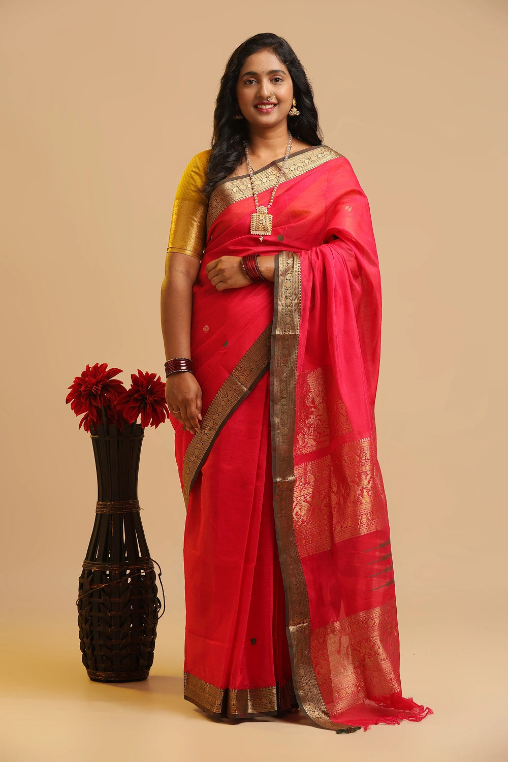 Full-length studio view showcasing the graceful drape and rich colour of the corner butta silk cotton saree