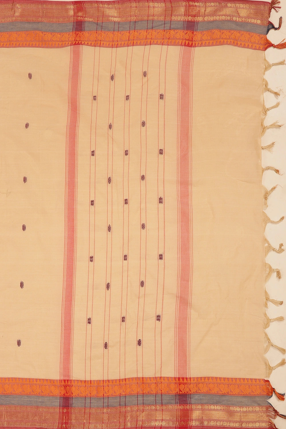 Detailed view of the delicate woven motifs across the off-white cotton saree body