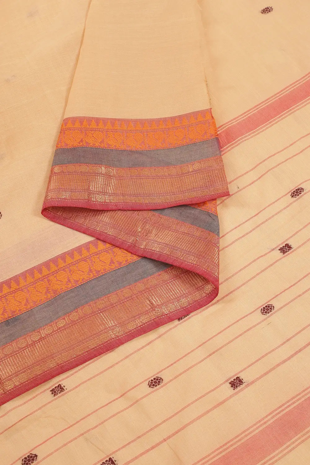 Folded view showcasing the smooth pure cotton texture and traditional border work