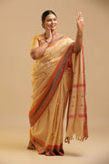 Cream Kanchipuram-inspired pure cotton saree featuring contrasting red and grey borders displayed by a model