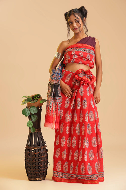 Studio standing angle view showcasing the graceful drape and vibrant red color palette of the handblock printed Chanderi cotton-silk saree