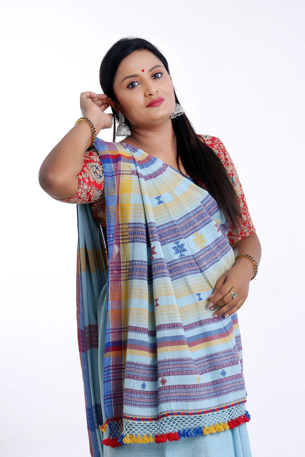 Close-up front view highlighting the shoulder drape, patterned blouse pairing, and vibrant border details