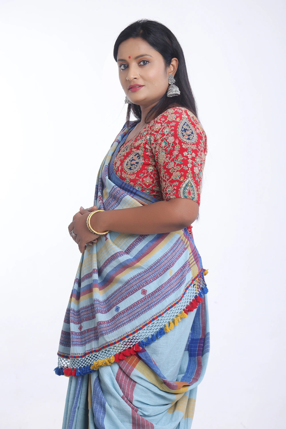 Side-profile studio view showcasing the graceful drape, pleat alignment, and detailed pallu structure of the Bhujodi saree