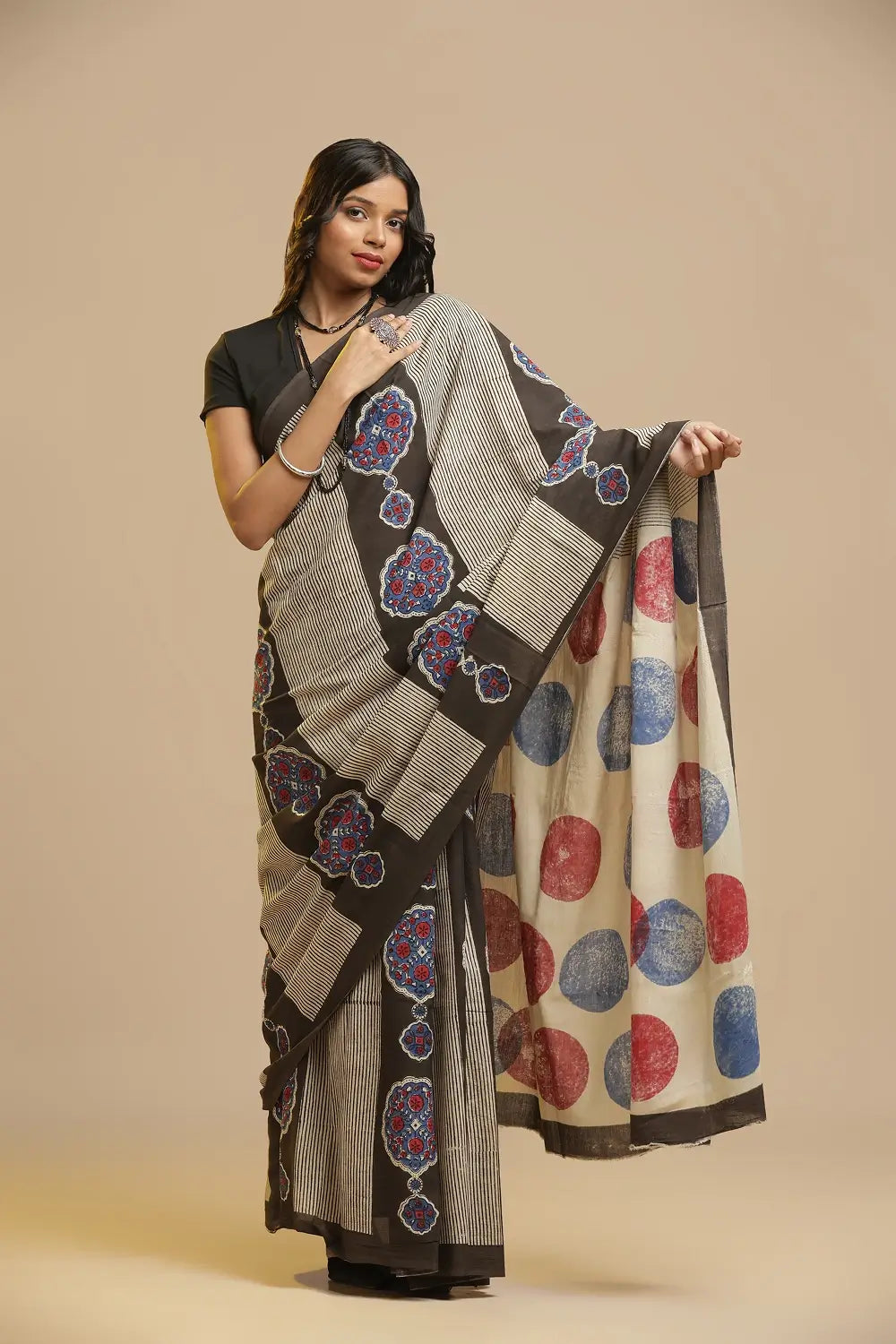 Earthy Elegance brown, indigo and red Bagru cotton saree featuring a polka-dot pallu displayed by a standing model