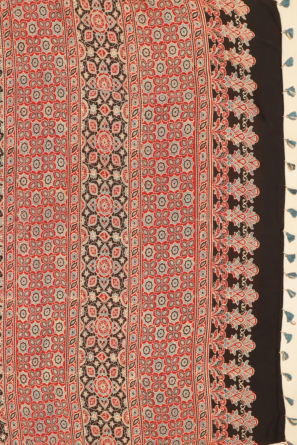 Studio view showcasing the intricate geometric motifs and artisan handblock print craftsmanship on the saree's pallu

