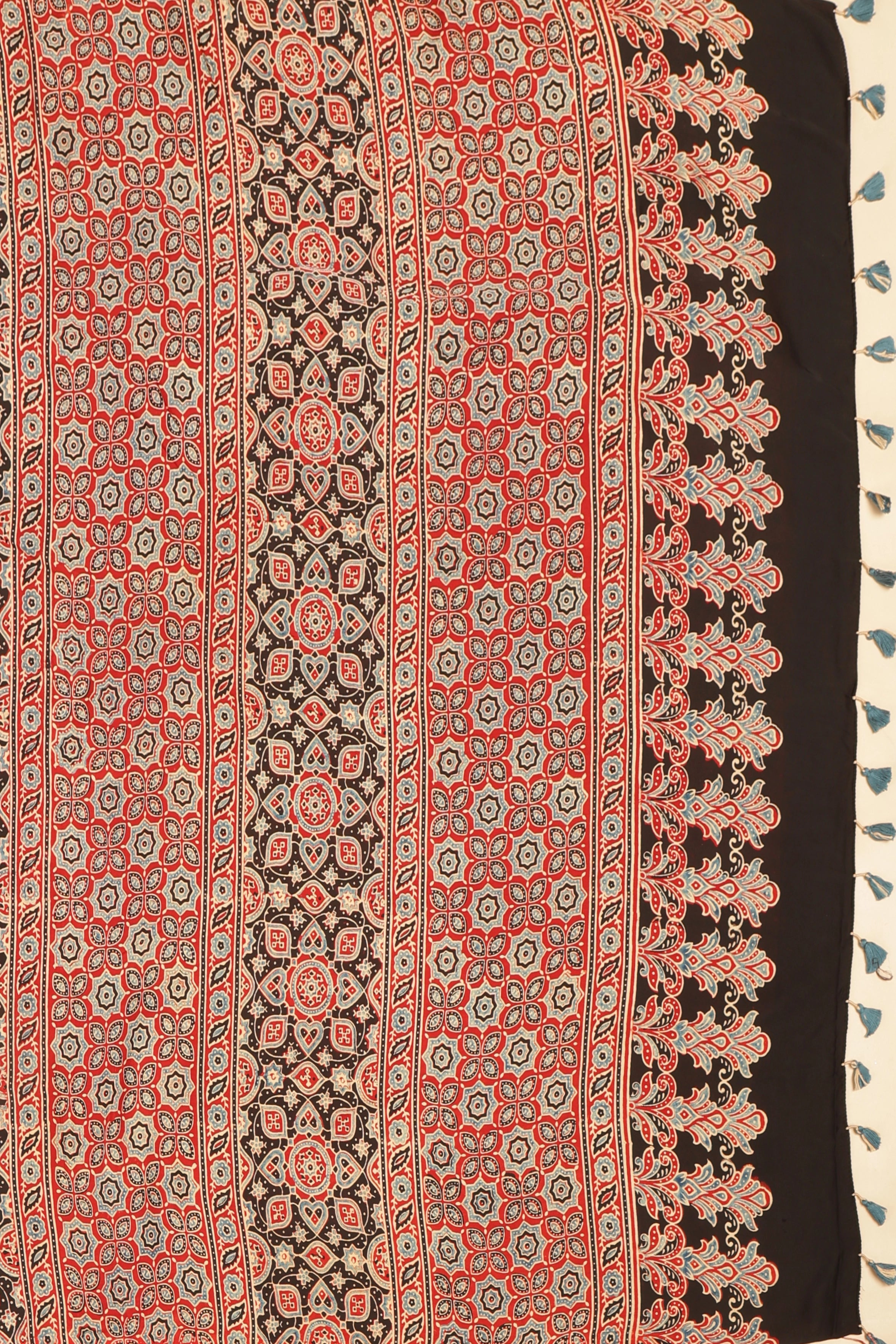 Studio view showcasing the intricate geometric motifs and artisan handblock print craftsmanship on the saree's pallu

