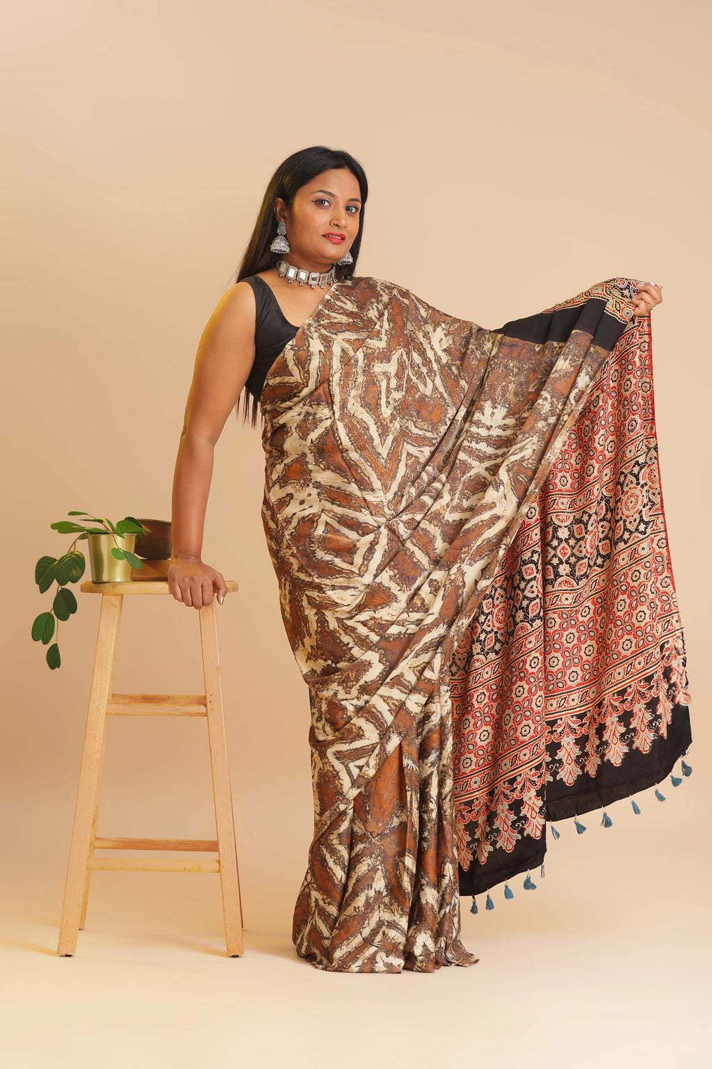 Studio standing full view showcasing the graceful drape and abstract marble pattern of the Ajrakh modal silk saree
