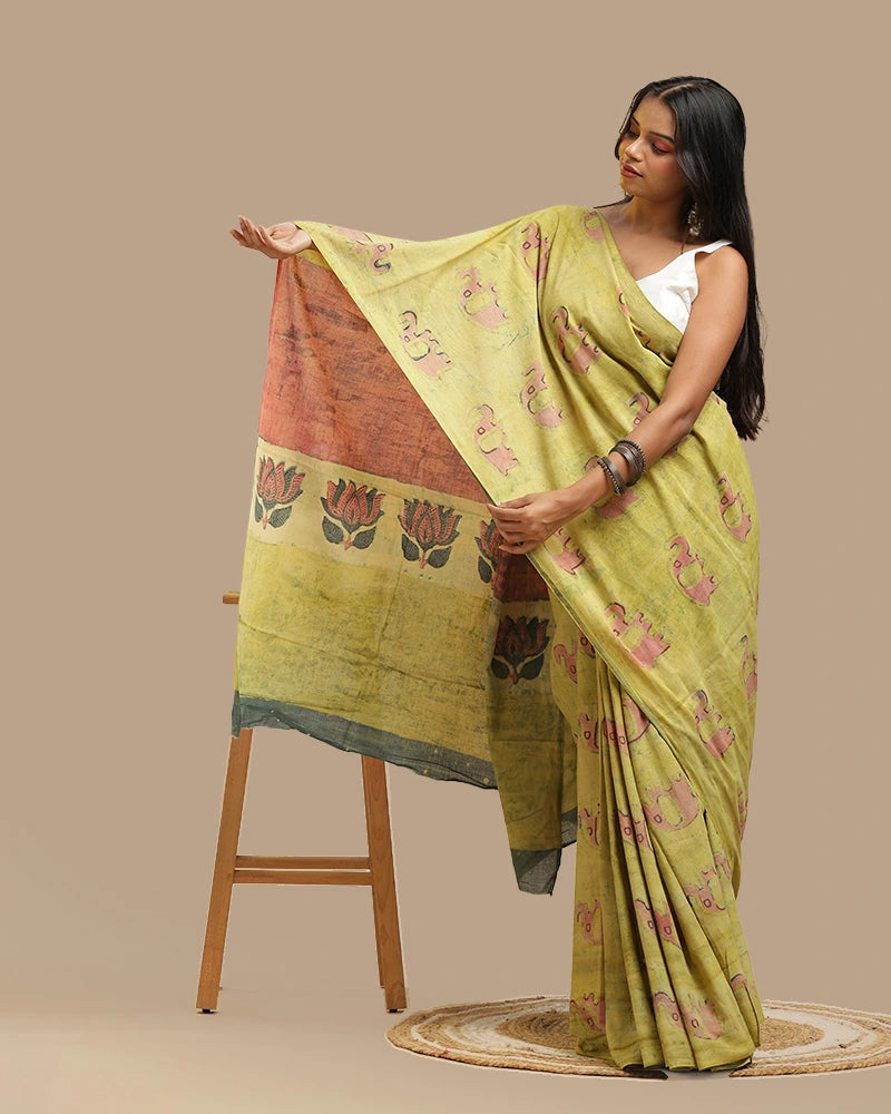 Model displaying the striking red and black lotus motif pallu of the moss green handblock print saree
