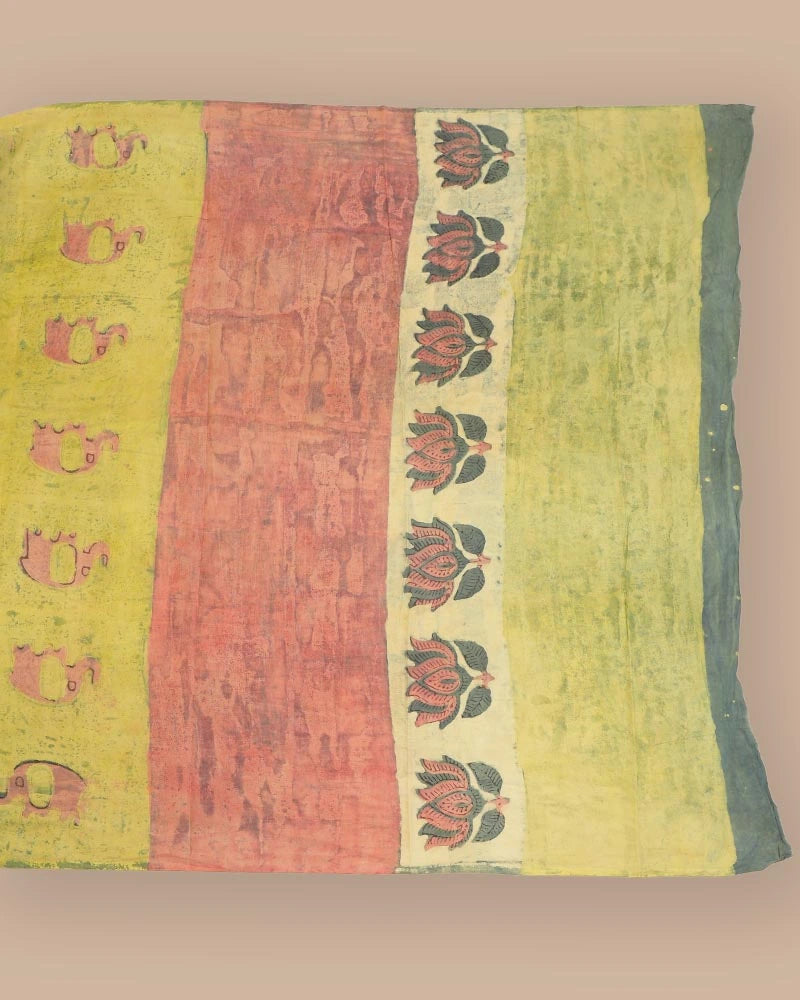 Flat lay detail view showing the colorful printed panels and traditional Bagru motifs of the moss green cotton saree