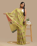 Moss green handblock print cotton saree featuring Bagru elephant and lotus motifs displayed by a model holding the pallu