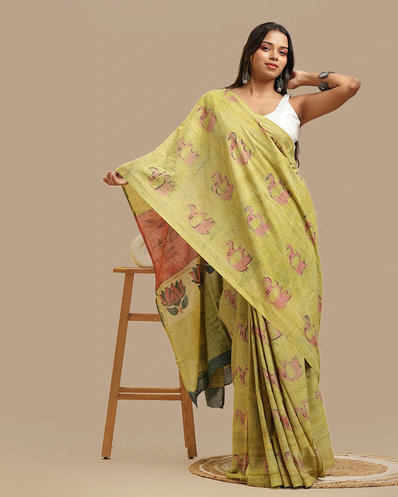 Model posing in the moss green handblock print saree, highlighting the patterned pallu and ethnic drape