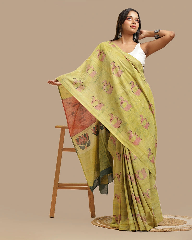 Side drape view of the moss green Bagru print cotton saree worn by a model against a neutral studio backdrop