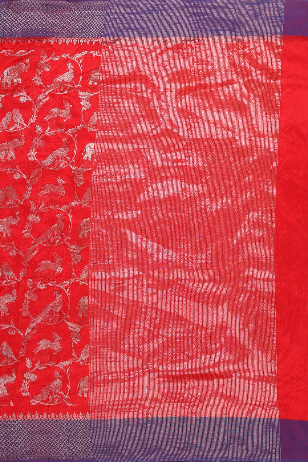 Flat-lay studio arrangement showcasing the intricate silver zari elephant motifs across the red Chanderi fabric