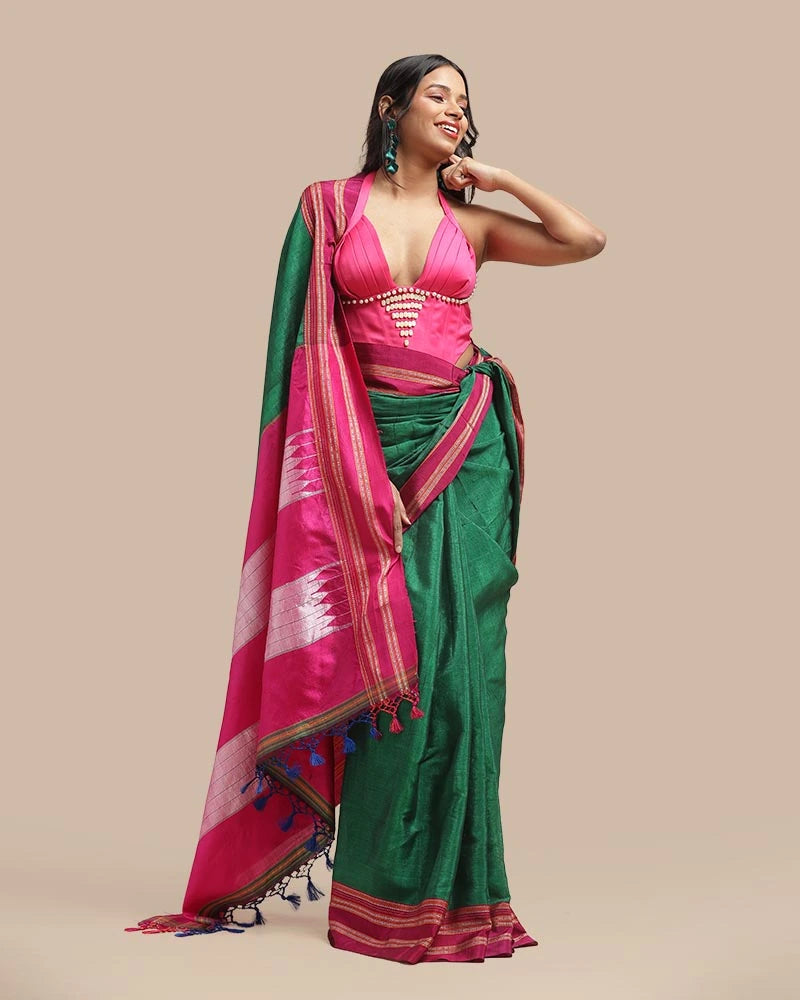 Side angle view showcasing the fall and drape of the emerald green cotton-silk body alongside the contrasting pink border
