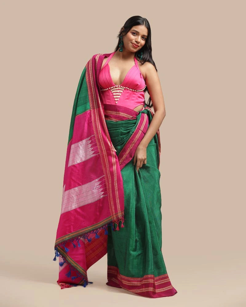Close-up standing studio shot highlighting the texture and rich drape of the emerald green cotton-silk body and pink border