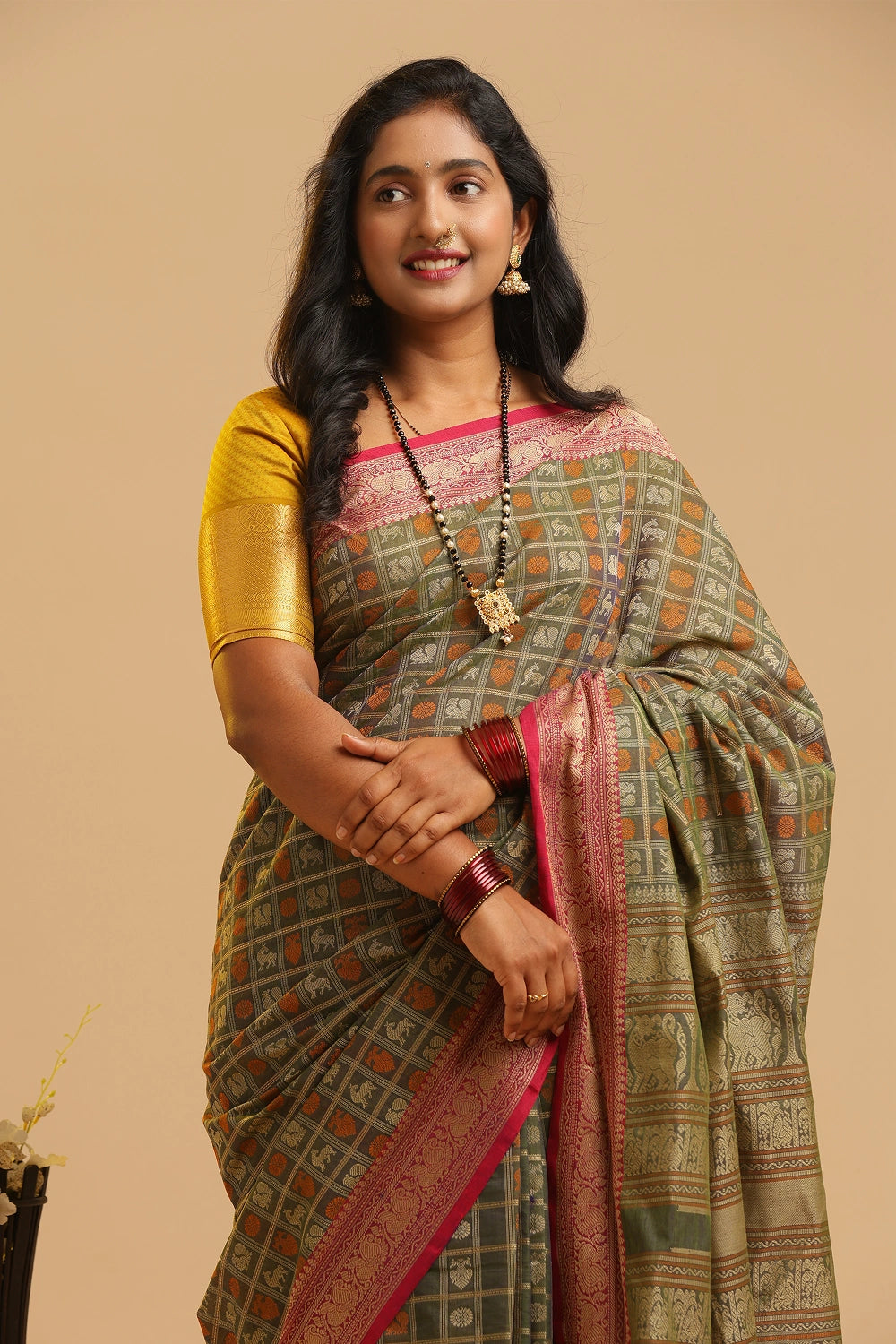 Emerald Elegance pista green Kanchipuram handloom cotton saree featuring two-tone 1000 butta motifs displayed by a model