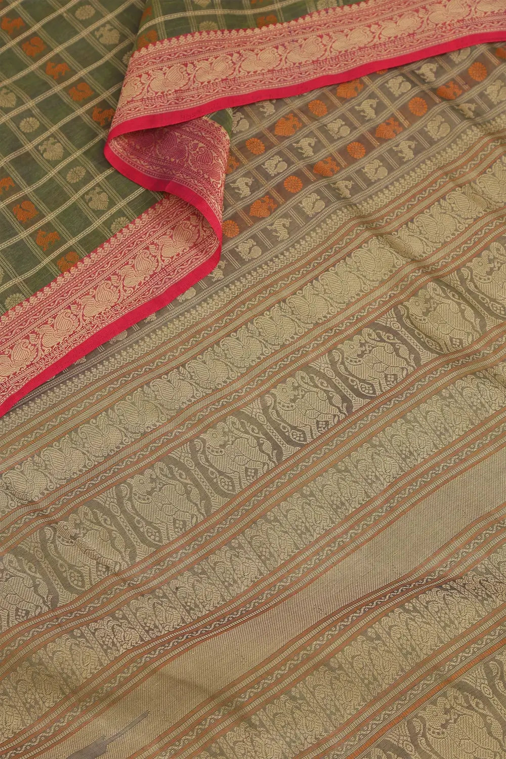 Detailed view of the intricate two-tone thread work and individual butta motifs across the pista green cotton body