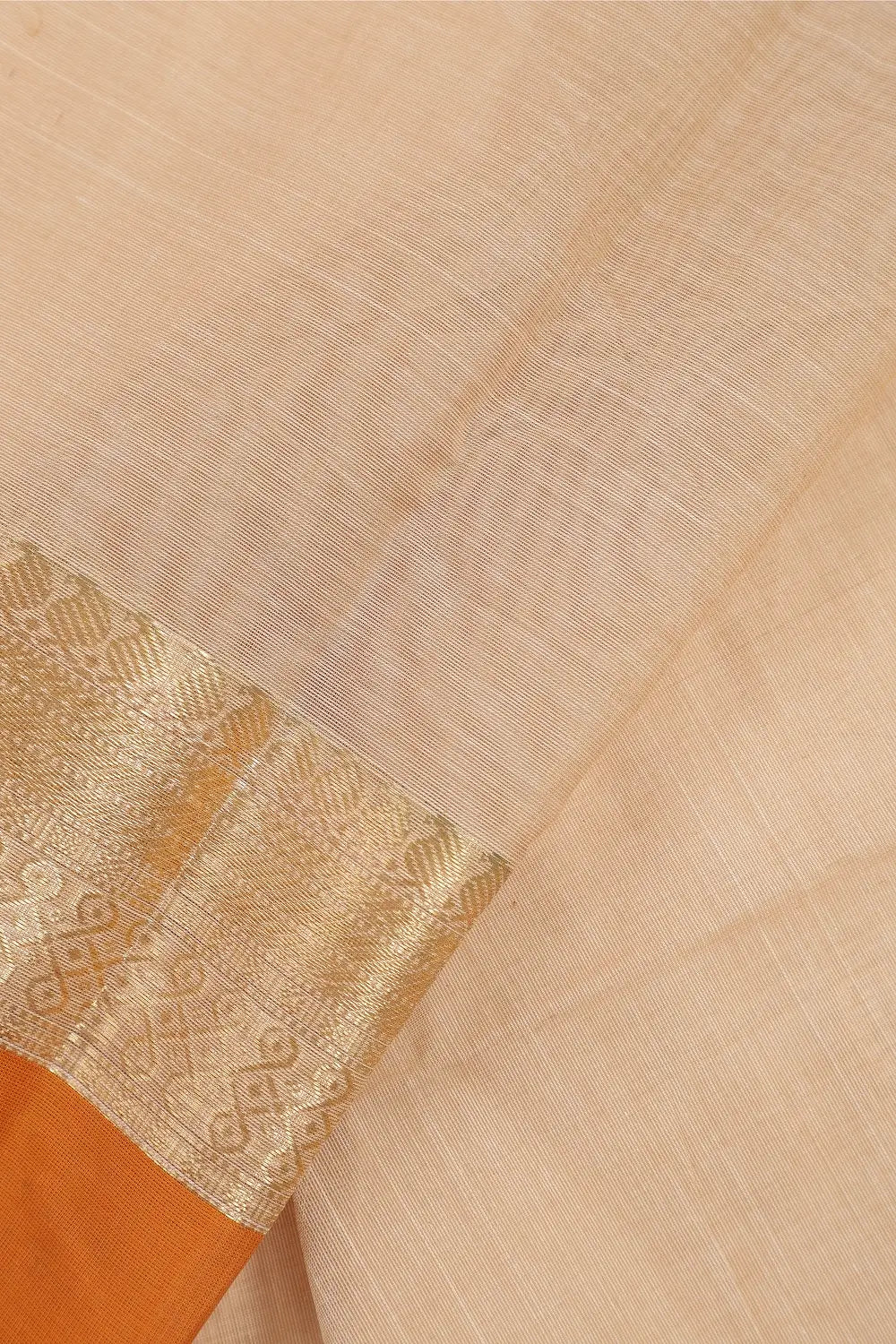 Close-up view of the refined gold zari border framing the pure handloom cotton body