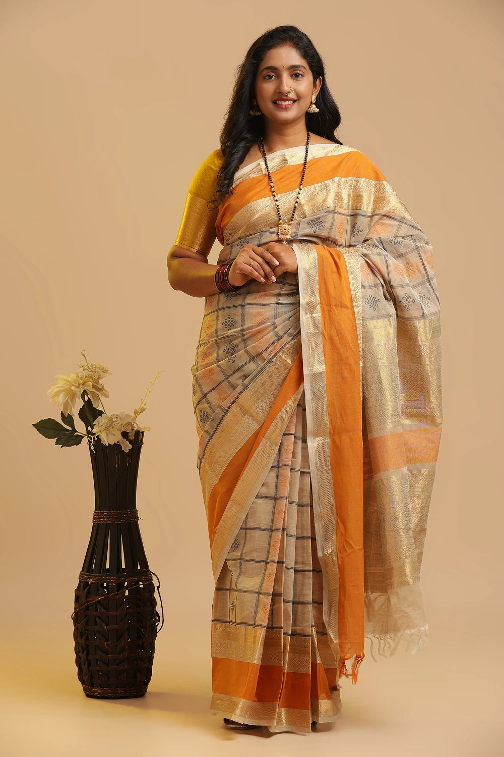 Festive Allure Kolam Kanchipuram handloom cotton saree with 1000 butta motifs and gold zari border displayed by a model