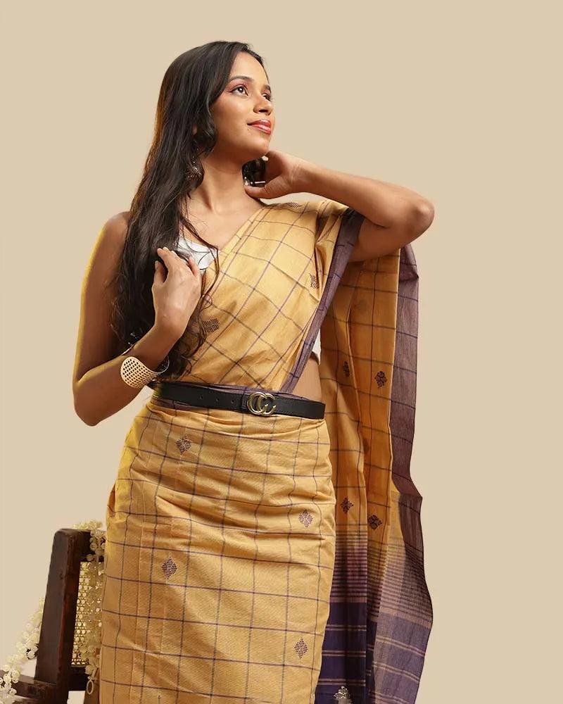 Close-up upper body view showcasing the golden ochre checked weave, buti motifs, and blouse styling of the Kasaragod saree