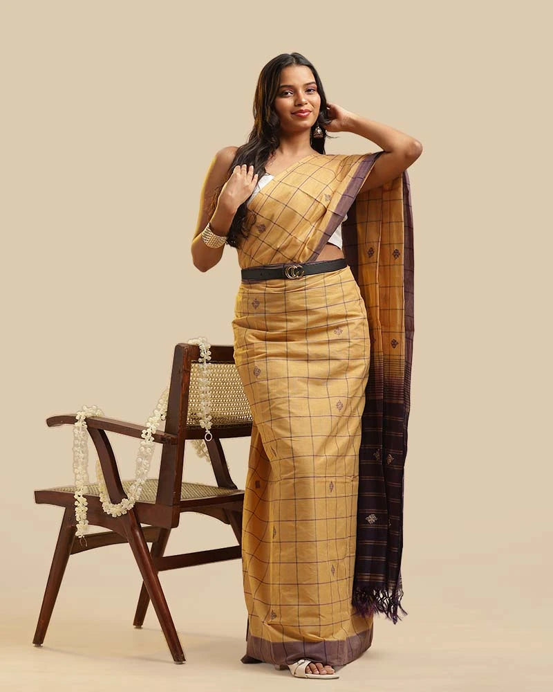 Side-profile studio view highlighting the shoulder pleats, refined royal purple border, and graceful silhouette of the saree
