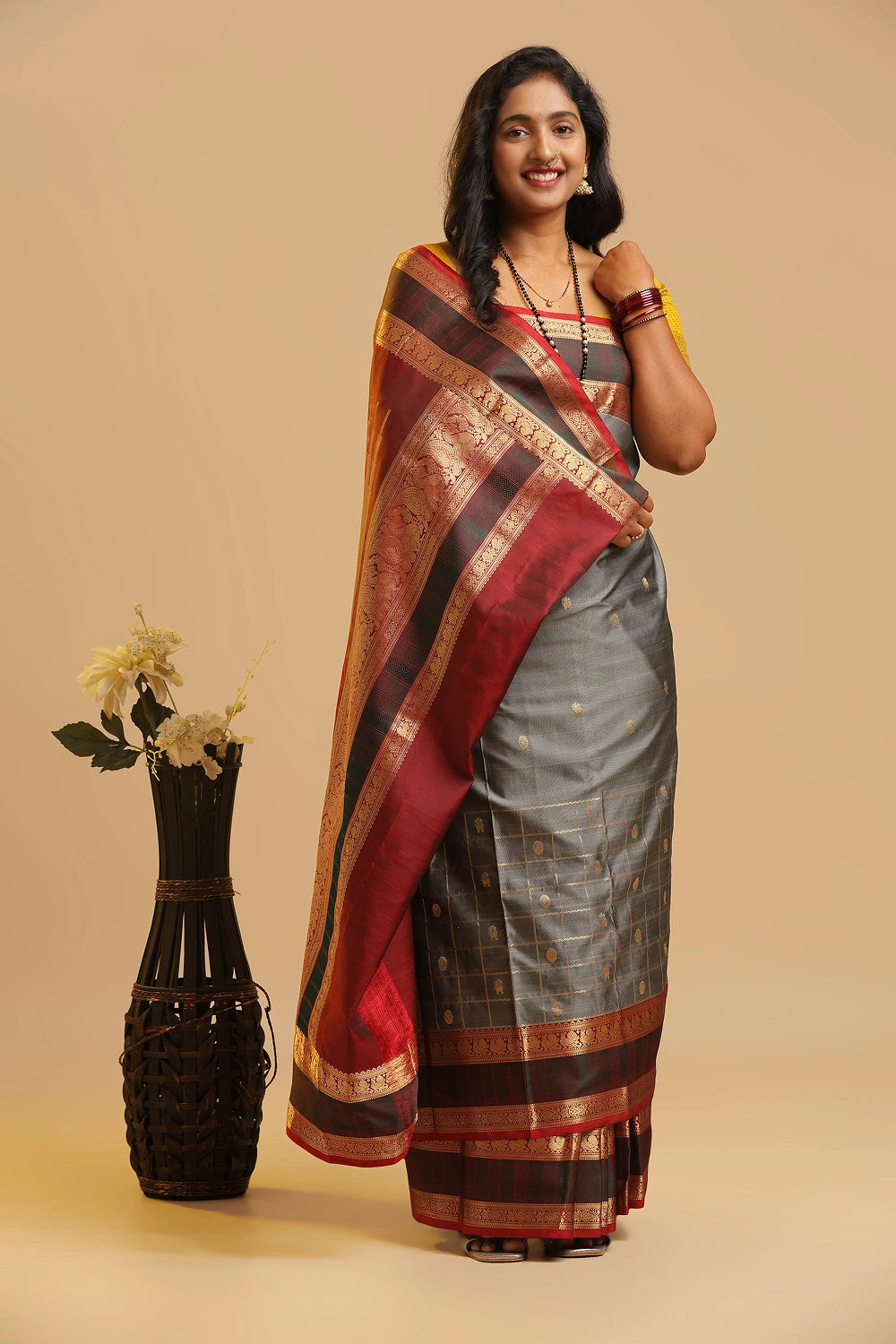 Grey half-and-half Kanchipuram handloom silk saree with rich maroon contrast pallu and real gold zari displayed by a model