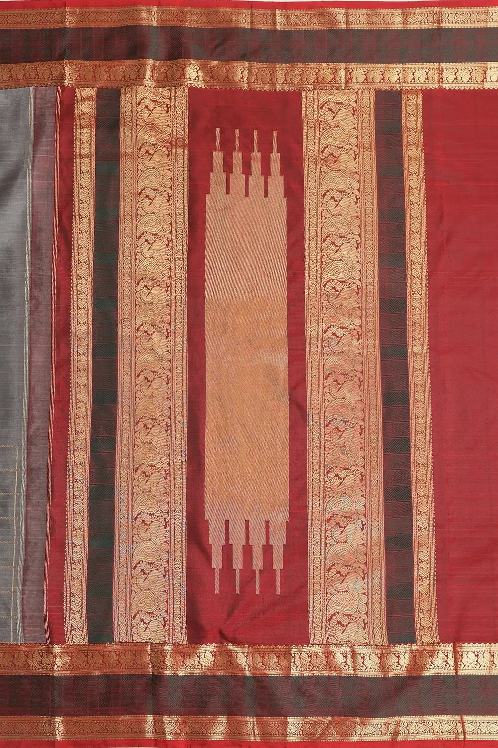 Close-up view of the traditional pit loom weave and gold zari motifs on the pure mulberry silk fabric
