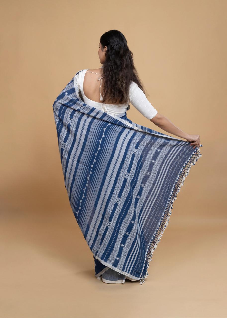 Rear view of a model displaying the detailed vertical striped pallu composition and crochet-lace edge