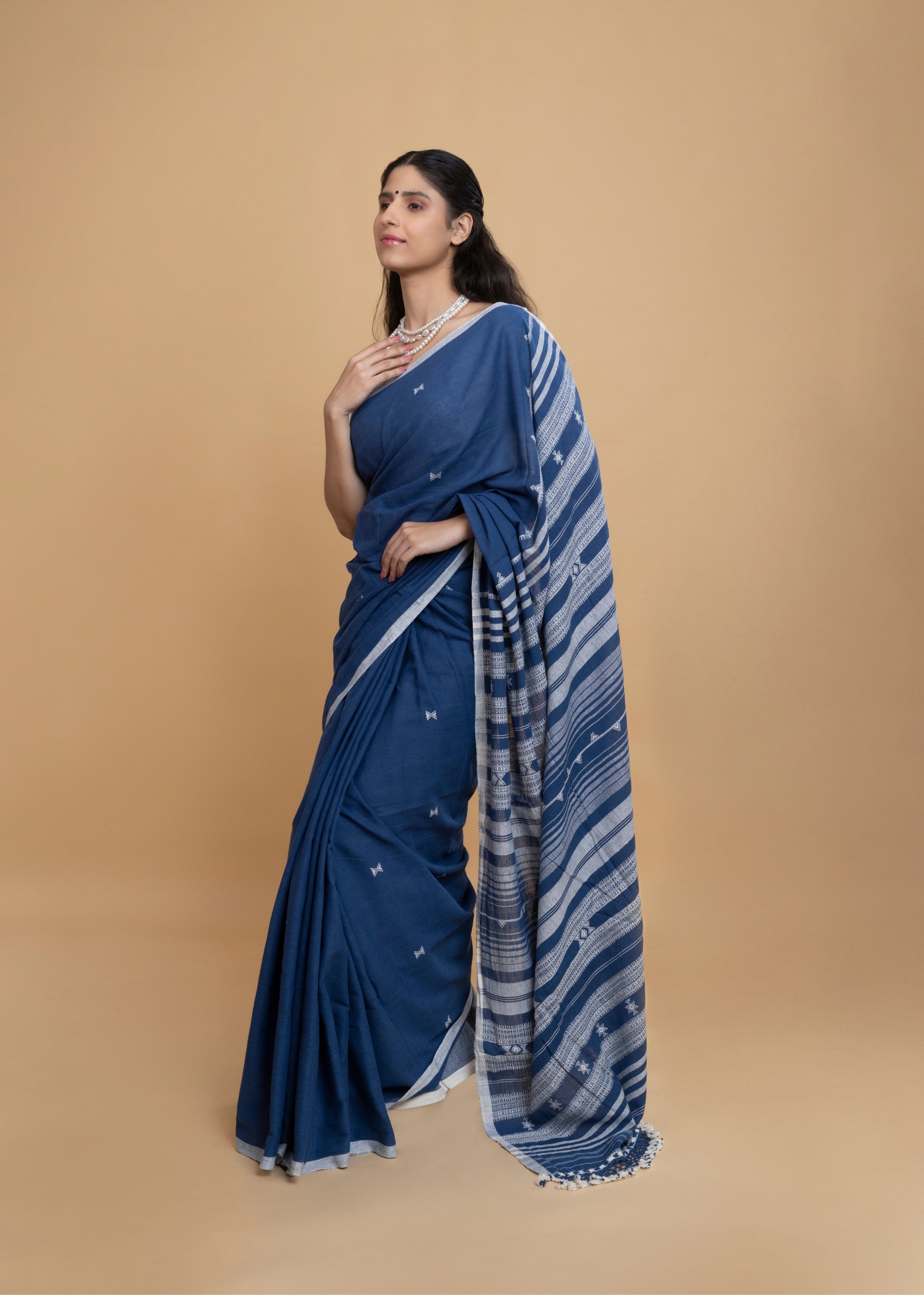 Front-facing studio pose showcasing the graceful drape and sophisticated colour palette of the indigo Bhujodi saree