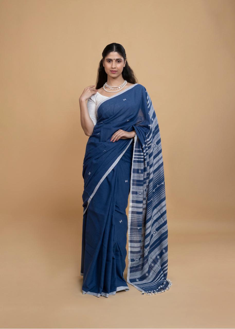 Full-length view of a model wearing the deep indigo blue organic Kala cotton Bhujodi saree with clean ivory-grey borders