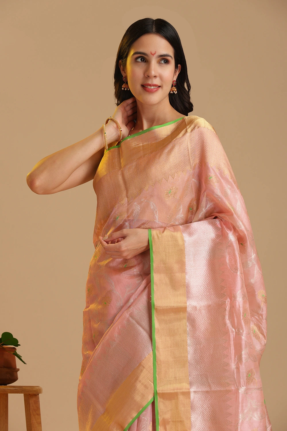 Studio standing angle view showcasing the graceful drape and elegant soft blush pink and gold color palette of the Chanderi pattu silk saree