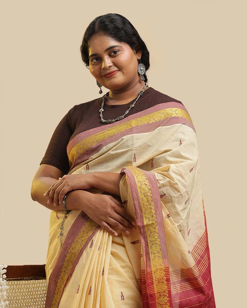 Close-up front view showcasing the ivory cream body, mustard buti motifs, and blouse pairing of the Kasaragod saree