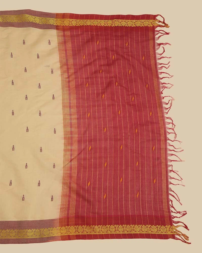 Detailed close-up of the rich maroon pallu featuring woven checks, traditional motifs, and hand-tied tassel fringe
