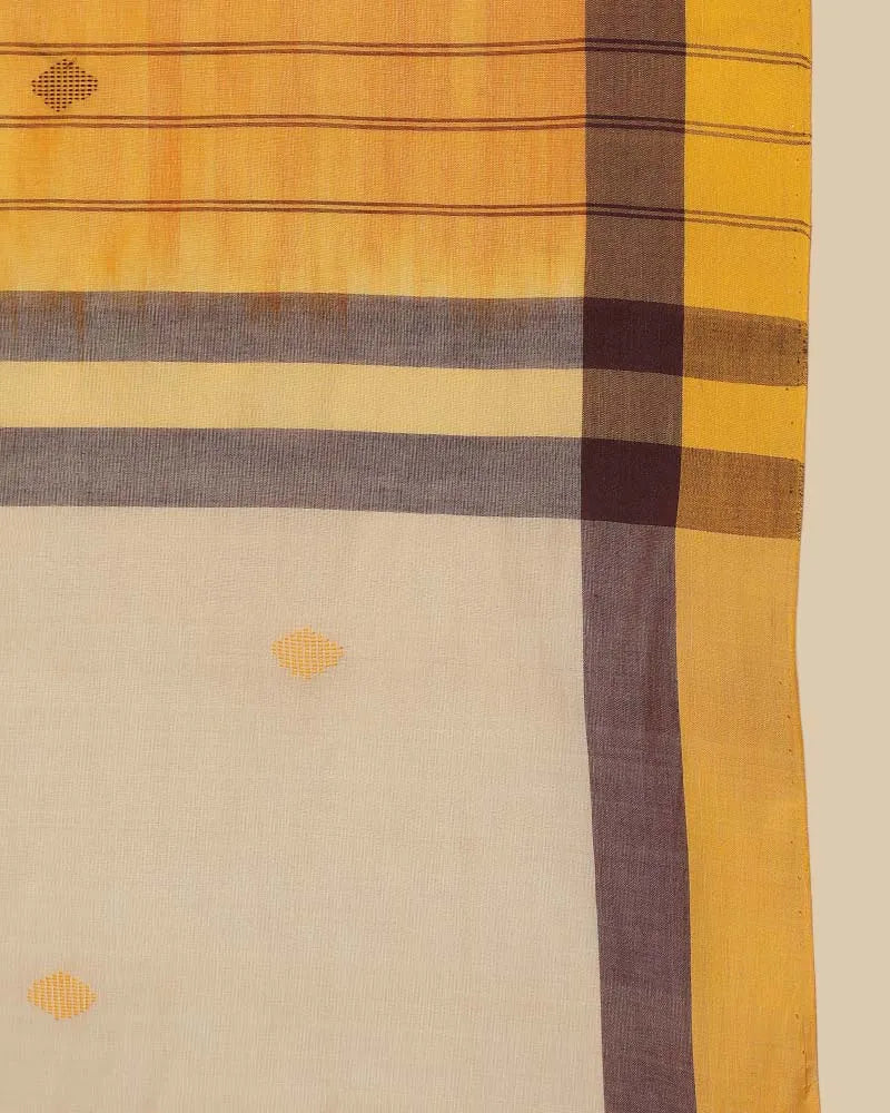 Close-up fabric shot highlighting the soft ivory body weave, mustard buti motifs, and mustard border framed with fine grey accents
