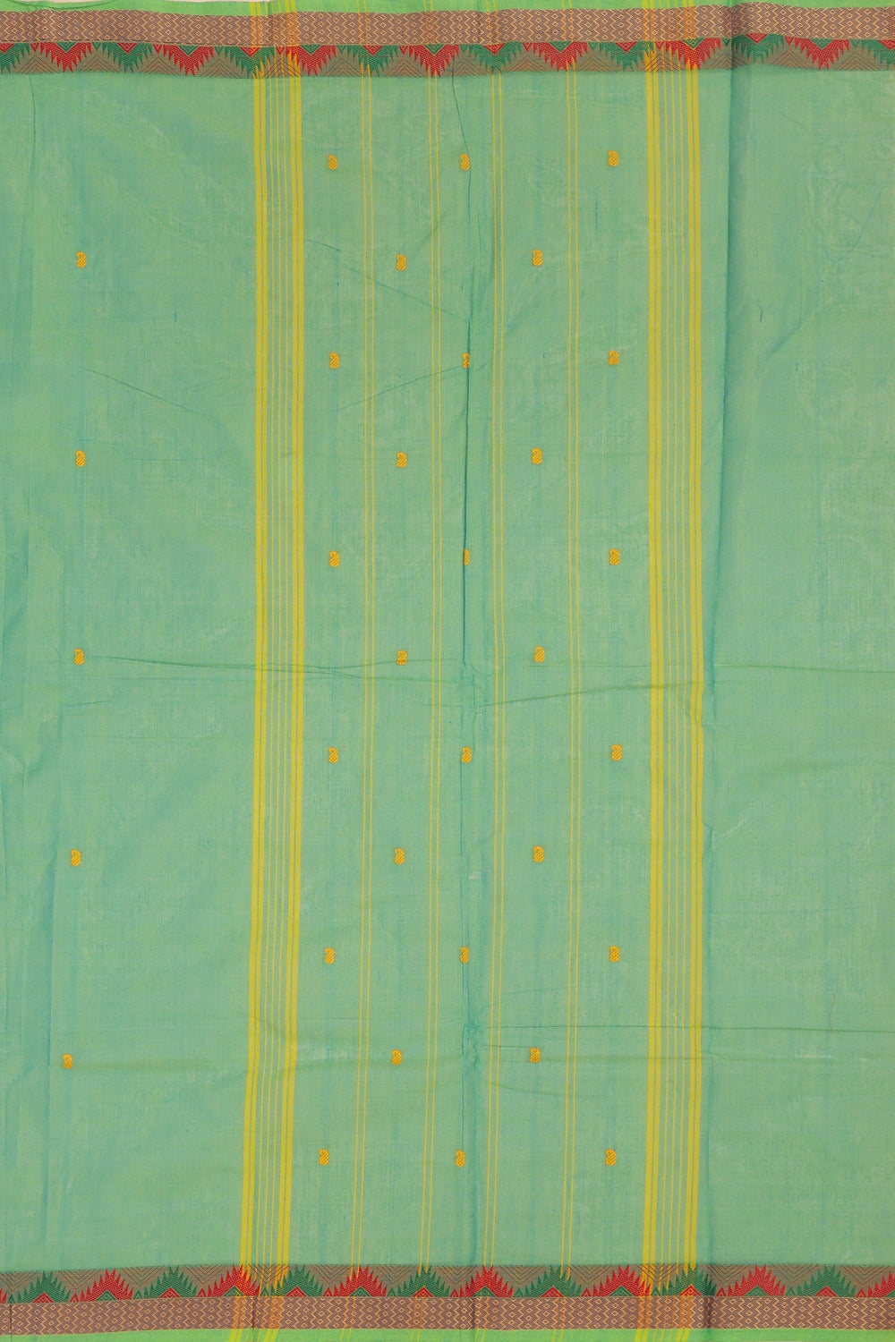 Detailed view of the woven stripes and border pattern on the light green saree