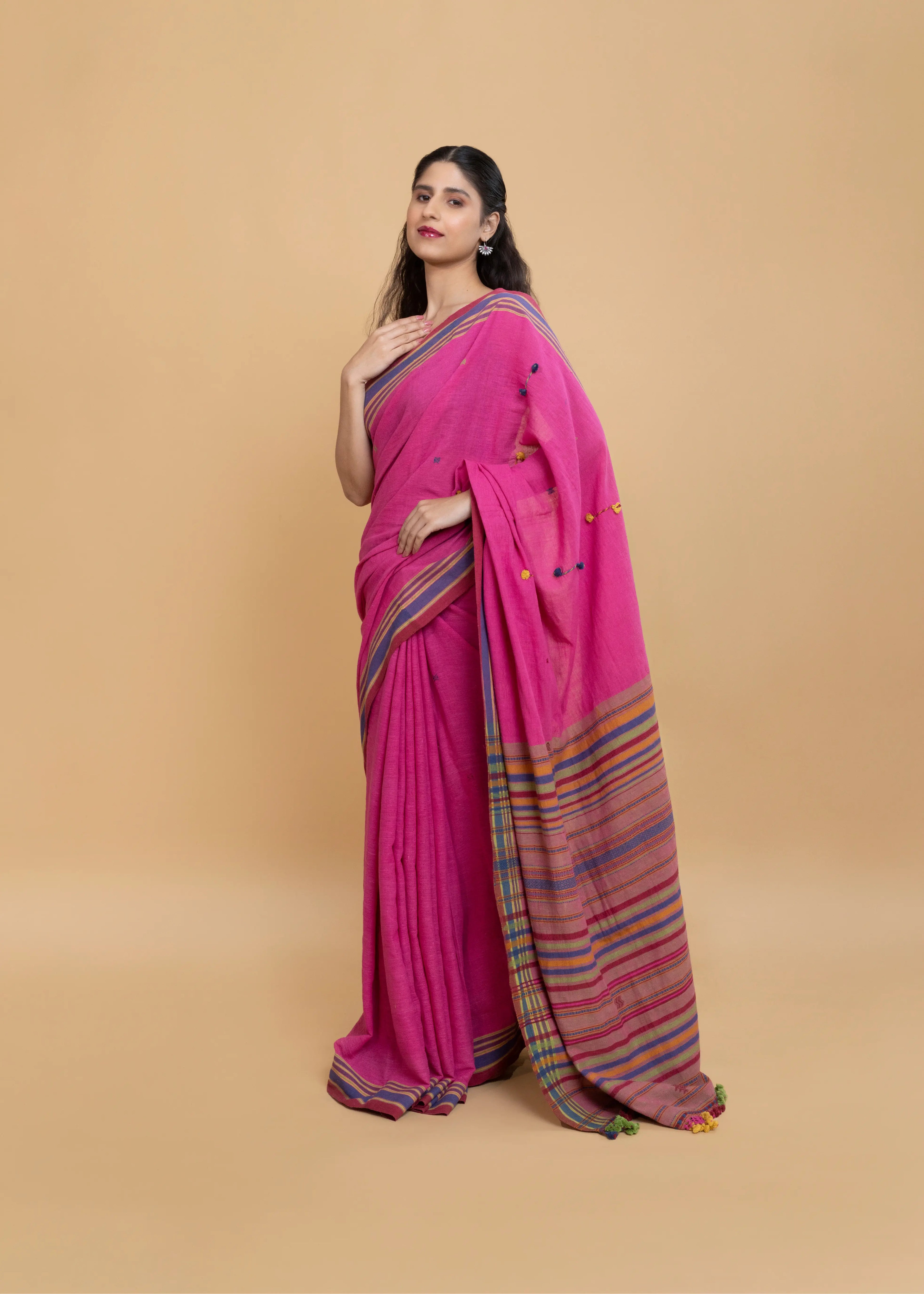 Front-facing studio pose showcasing the drape and vibrant colour palette of the magenta Bhujodi saree