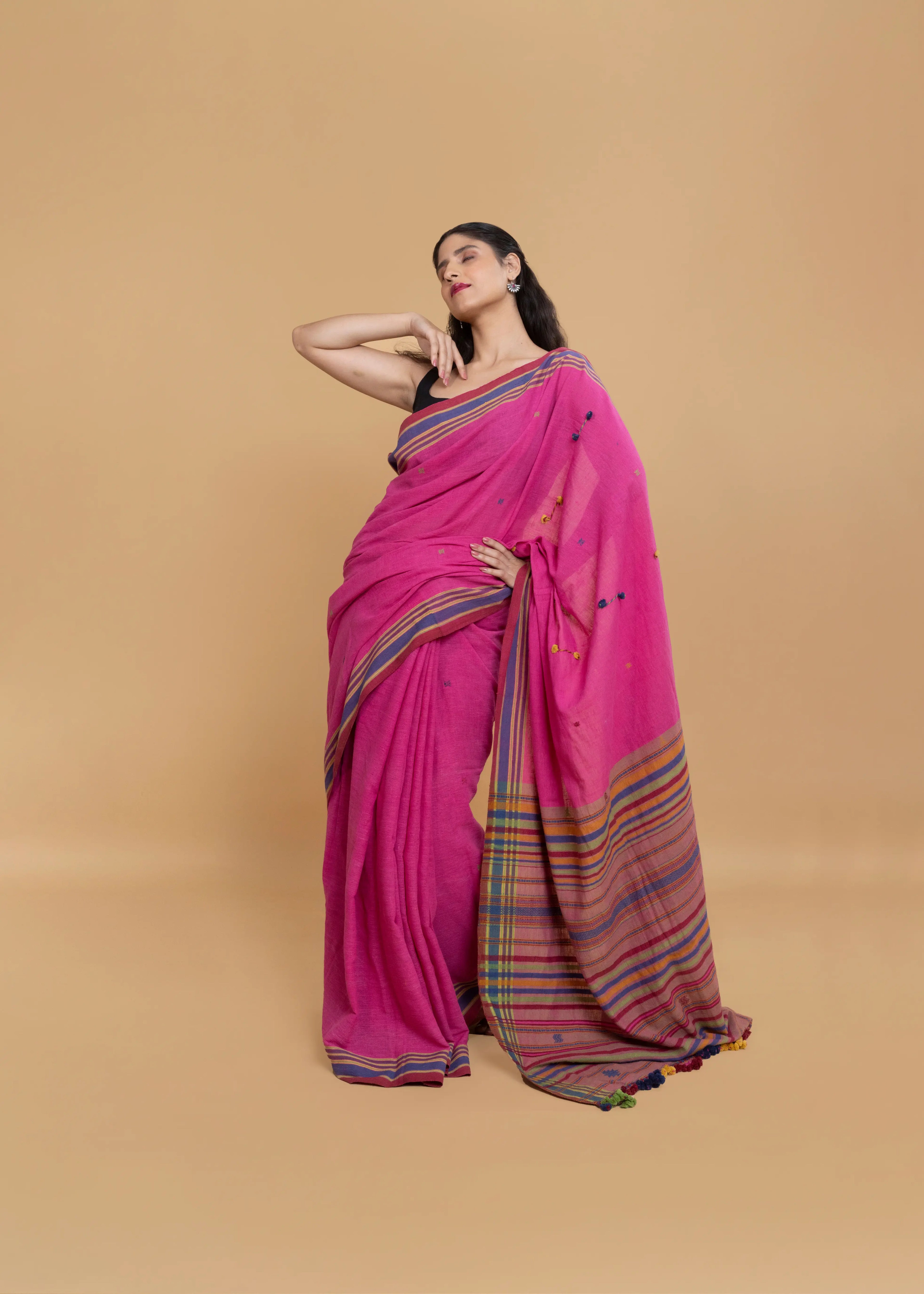 Full-length view of a model wearing the magenta pink organic Kala cotton Bhujodi saree with multicolour striped borders